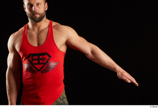 Dave  1 arm dressed flexing front view red tank…